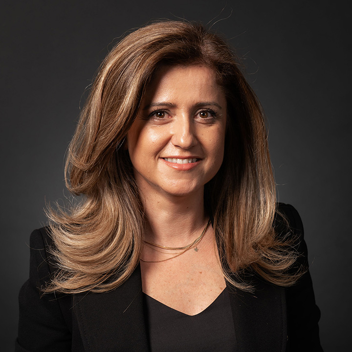 Photo of a smartly dressed woman in business attire.